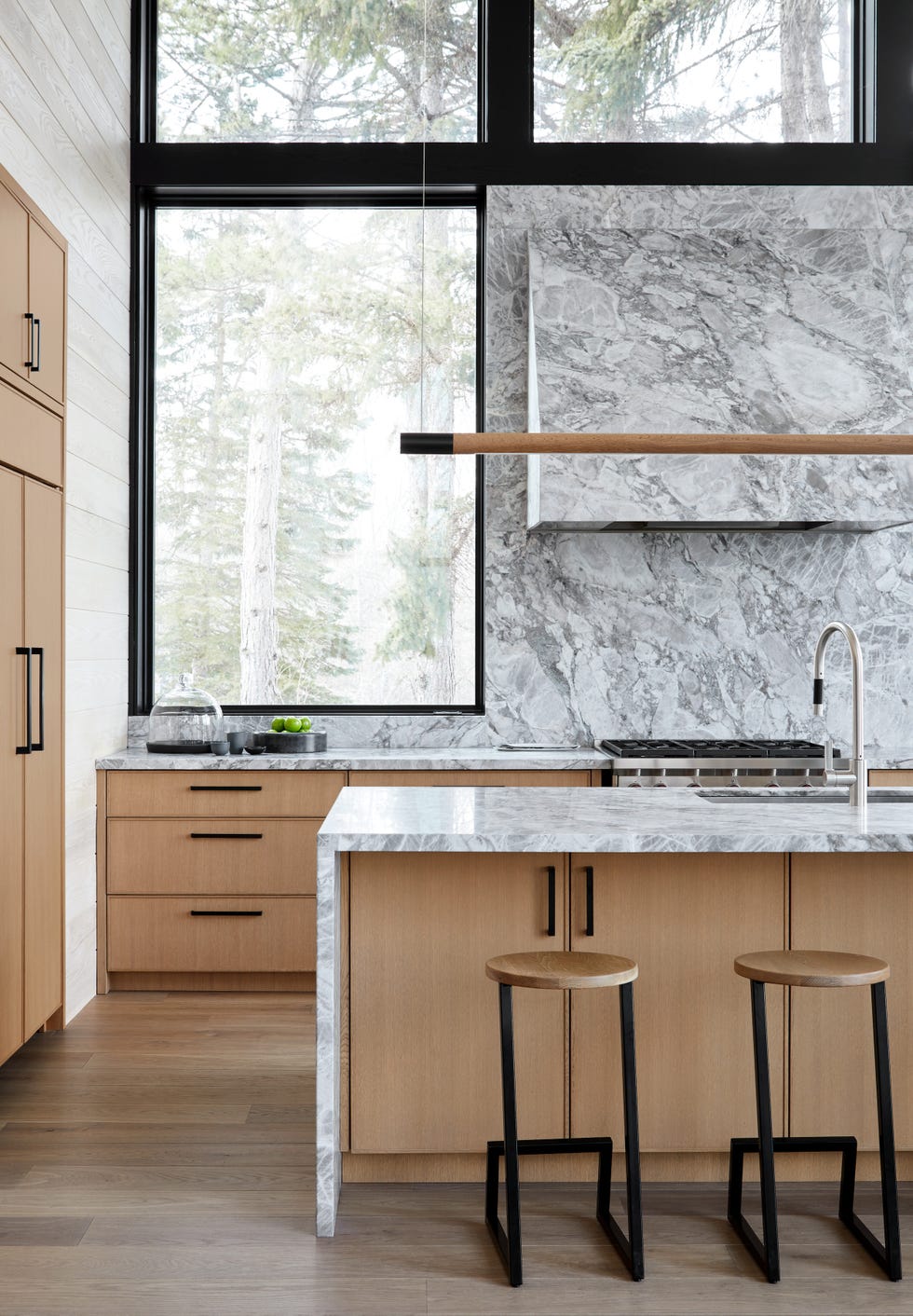 modern kitchen featuring wooden cabinets and marble countertops